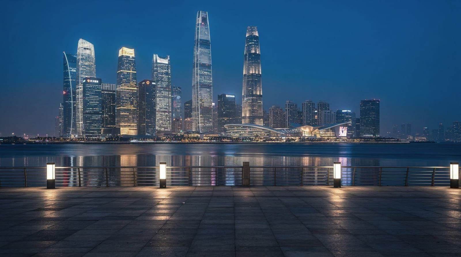 Shenzhen skyline at night with Futian CBD towers reflected in the bay